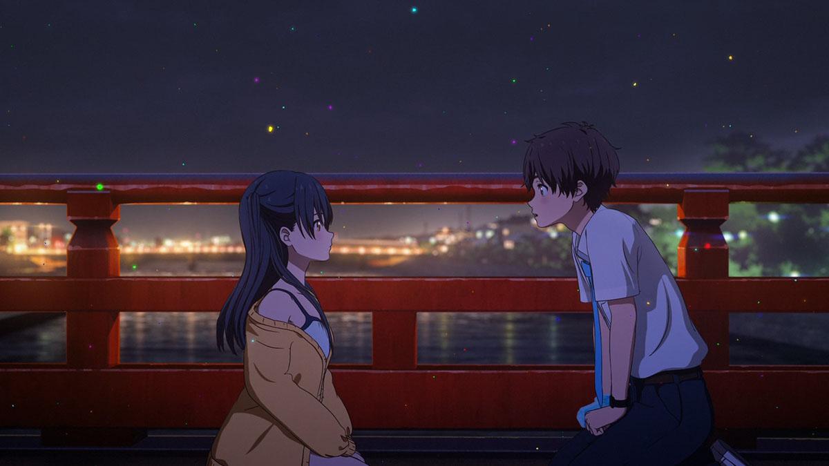 A mesmerizing scene from the movie 'Hello World' depicts the two protagonists sitting face to face on a bridge at night, their eyes locked in deep conversation, while the city's vibrant lights twinkle in the background, creating a captivating ambiance of connection, introspection, and the allure of urban dreams.