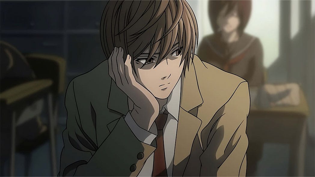 Light Yagami, the brilliant and enigmatic protagonist of Death Note, gazes pensively out of the classroom window. Bathed in the soft glow of sunlight, his intense expression hints at the profound thoughts swirling within.{caption: Light Yagami in Death Note (Episode 1)}
